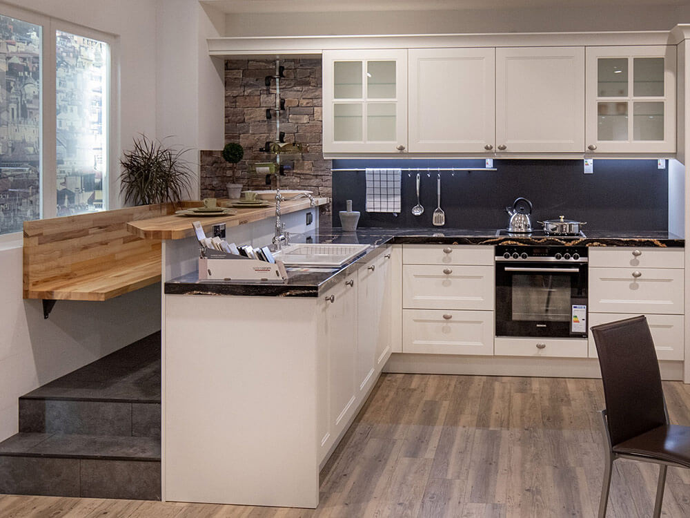 Hochgesetzte Sitzbank in einer Küche mit direkt an die Theke anschließenden Essplatz.