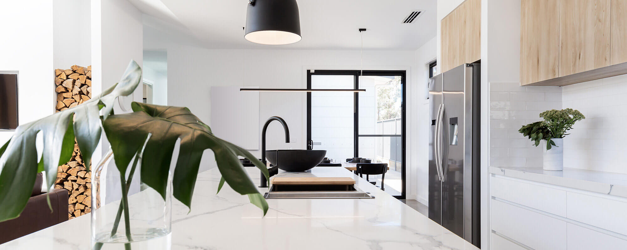 Moderne helle Küche mit Granit- oder Marmor-Arbeitsplatte, Holzfronten und Edelstahlkühlschrank
