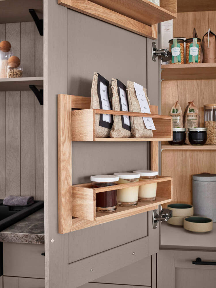 Detailansicht Innenausstattung Küche mit Gewürzregalen aus Holz an der Schranktür