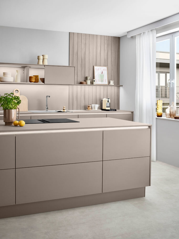 Kücheninsel-Detail mit flächenbündigem Induktionskochfeld und indirekter Griffmulden-Beleuchtung