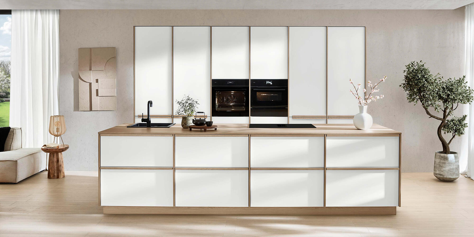 Helle minimalistische Kücheneinrichtung der Designlinie Sakura im Japandi-Stil mit Kochinsel und natürlichen Farben